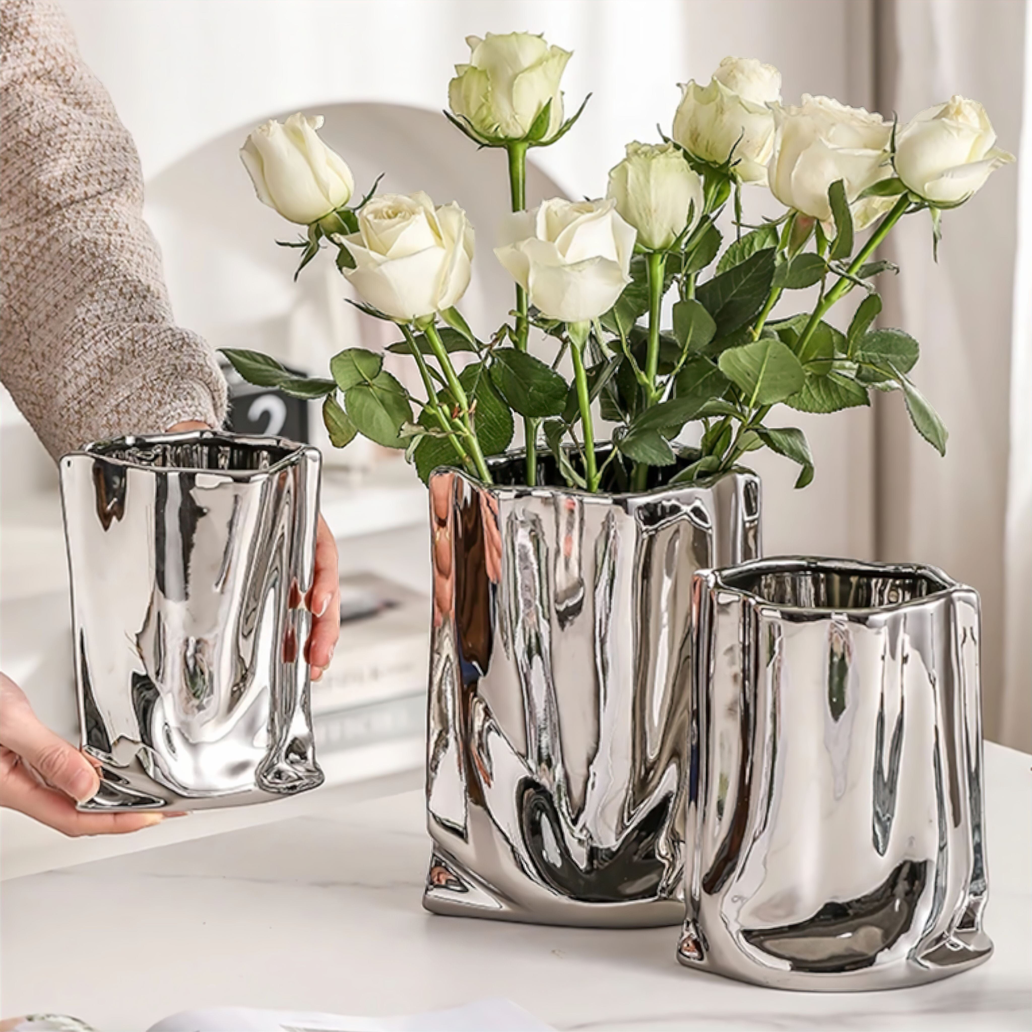 Silver Ceramic Sculpture Vase with Flowing Design and Reflective Chrome